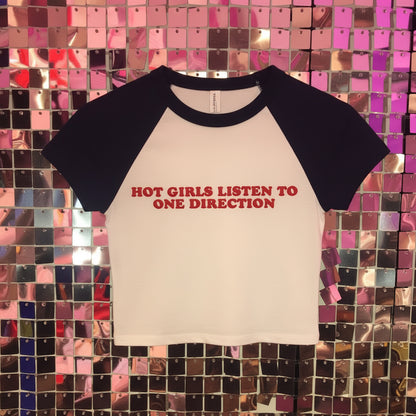 White shirt with red text on a colorful tiled background