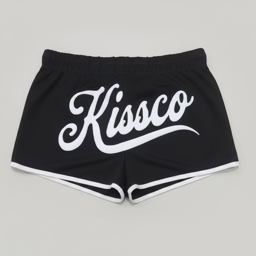 Red shorts with 'Kissco' branding on a checkered floor.