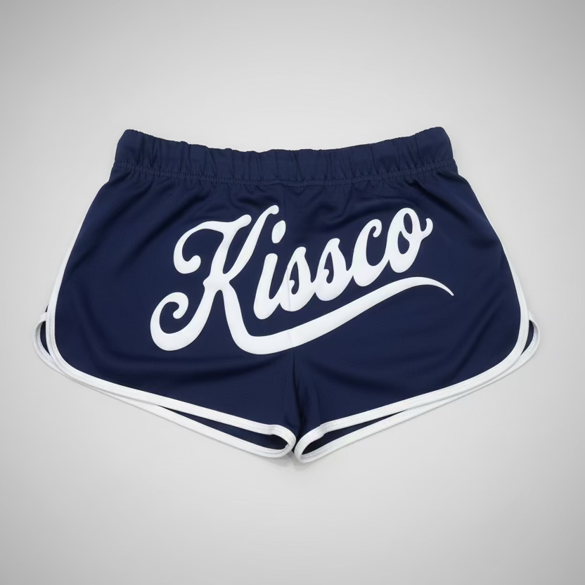Red shorts with 'Kissco' logo on a black and white checkered floor