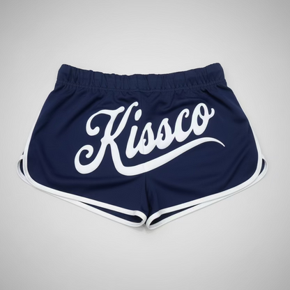 Red shorts with 'Kissco' logo on a black and white checkered floor