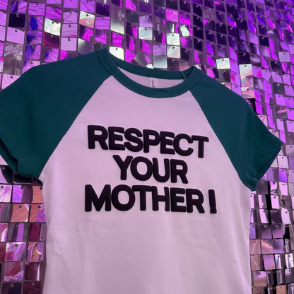 T-shirt with 'RESPECT YOUR MOTHER!' text on a hanger against a reflective, multicolored background