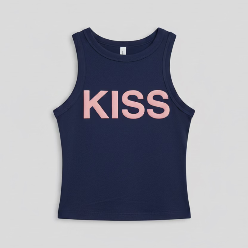 Navy blue tank top with 'KISS' printed in pink on a hanger against a reflective, multicolored background.